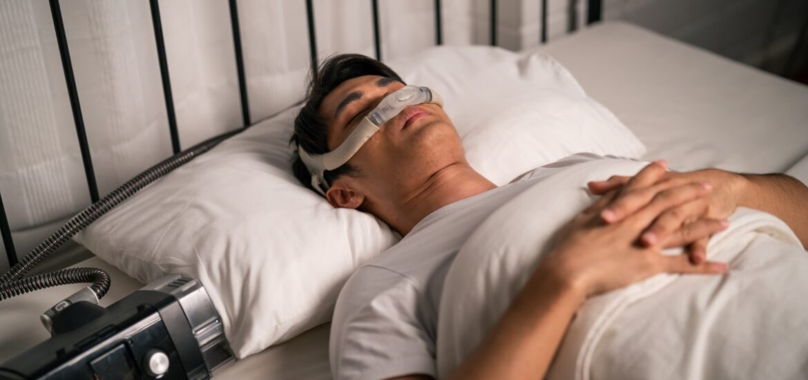 Man sleeping with a CPAP machine for sleep apnea